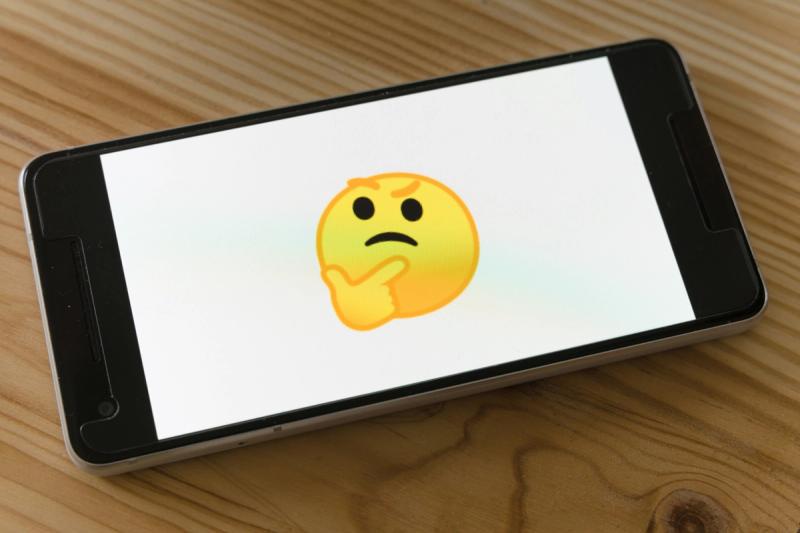 a thinking face emoji shown on a phone