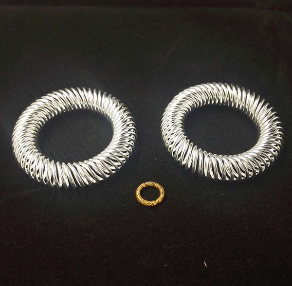Two large silver-plated canted coil spring rings and one small gold-plated canted coil spring ring