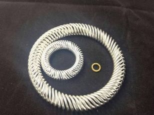 Three canted coil spring rings of varying sizes in silver and gold plating