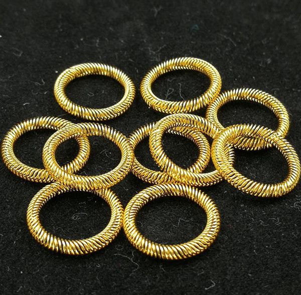 Gold-plated canted coil spring contact rings arranged on a dark background