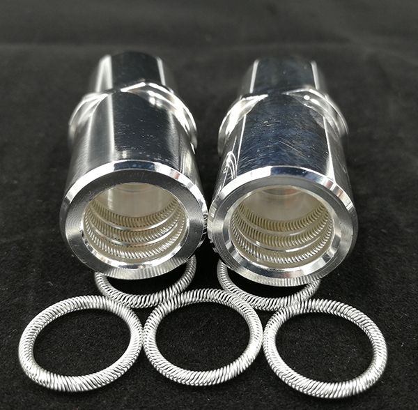 Two machined female connector sockets showing multiple internal canted coil spring rings with loose rings
