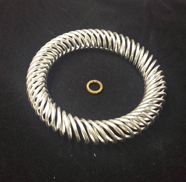 Large silver-plated canted coil spring ring alongside miniature gold-plated coil spring ring