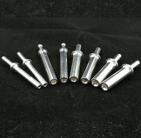 Silver-plated female socket connector terminals and precision machined contact sleeves on black background