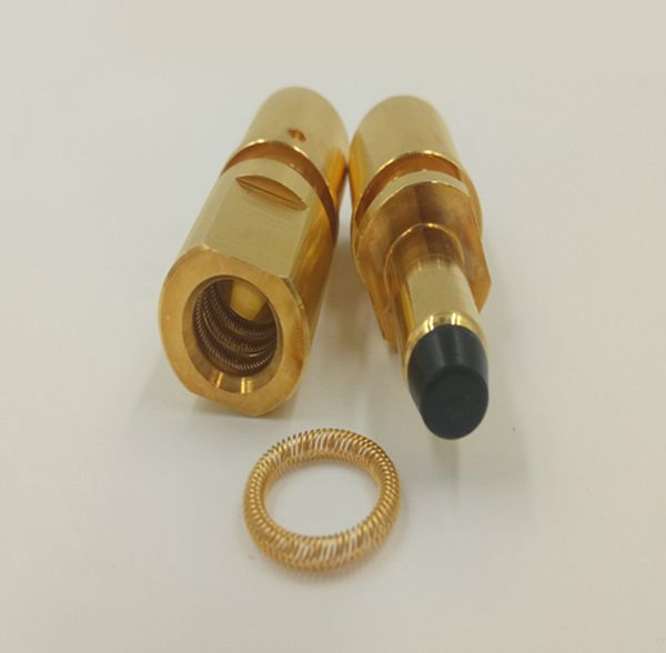 Gold-plated canted coil spring ring beside machined connector socket and mating pin