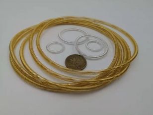 Gold and silver plated canted coil spring rings in multiple diameters with reference coin