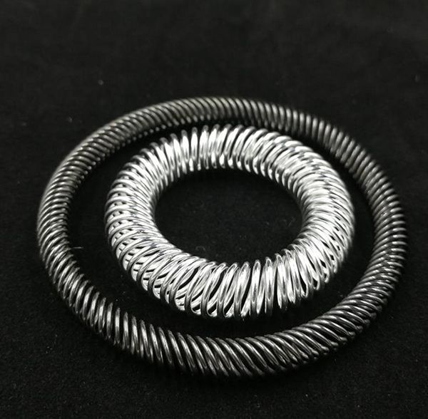 Two silver-plated circular canted coil spring rings of different diameters on black background