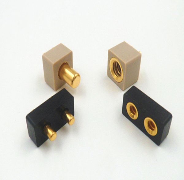 Gold-plated spring-loaded pin and canted coil socket connector pairs in plastic housings