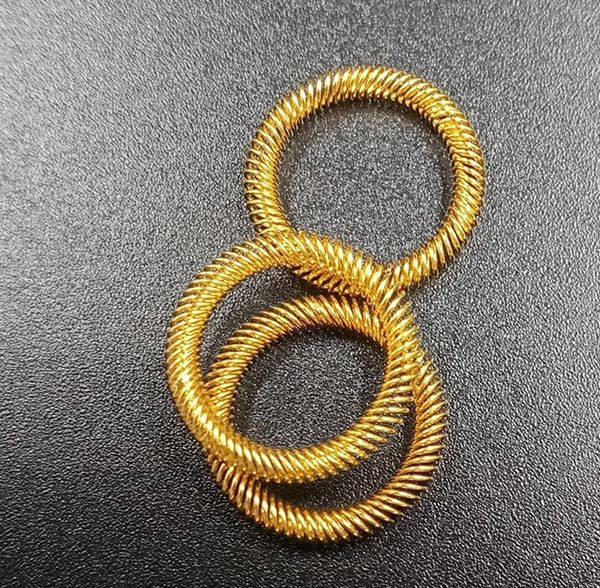 Gold-plated canted coil spring contact rings for electrical connector sockets on dark surface