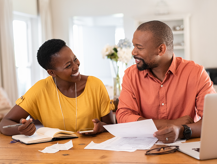 couple at kitchen table, looking at bills