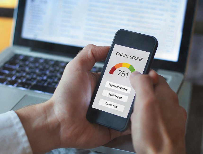 person holding a phone showing their credit score