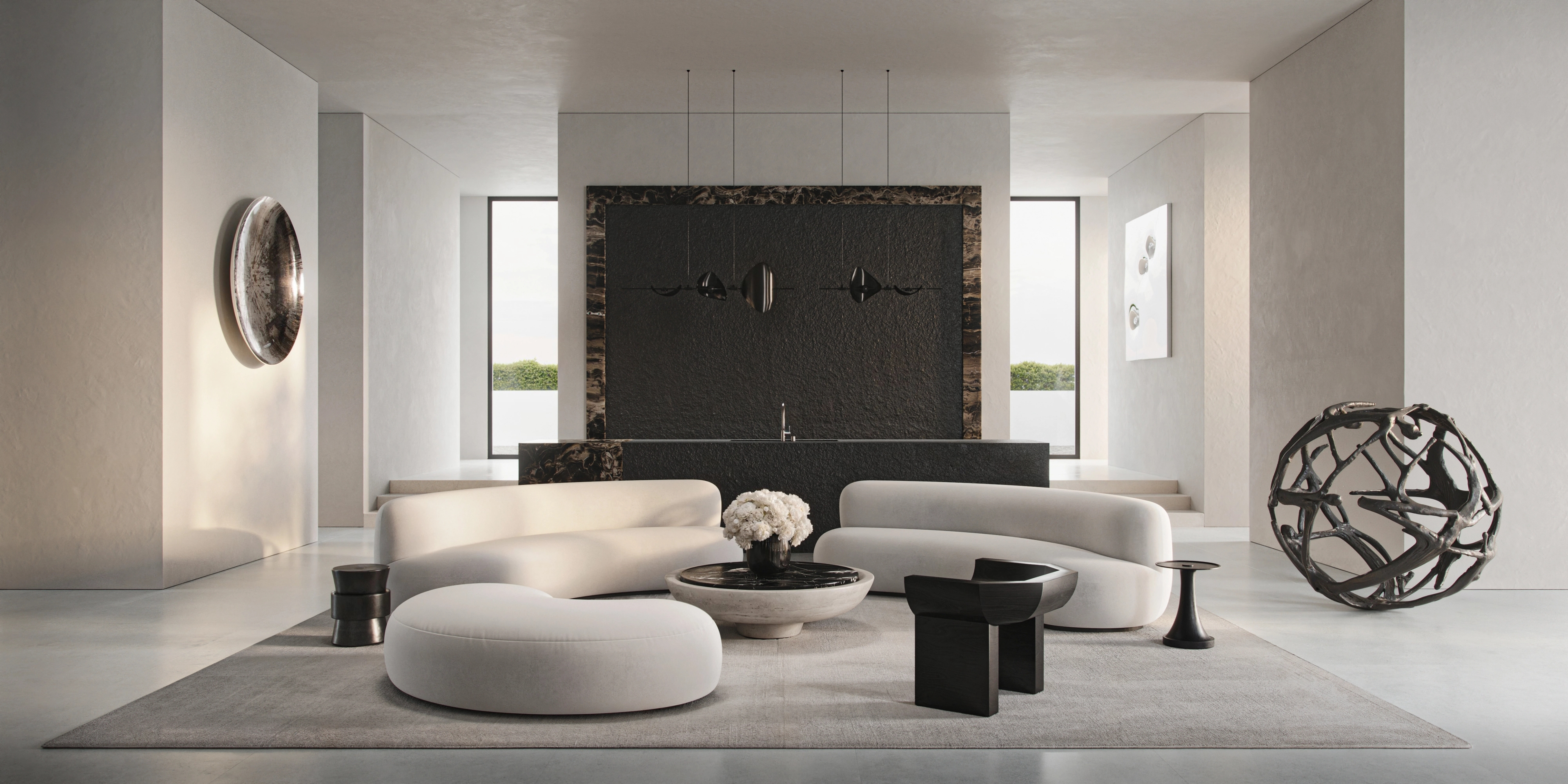 Principal living space with a monumental stone wall and sculptural lounge by Pierre Augustin Rose