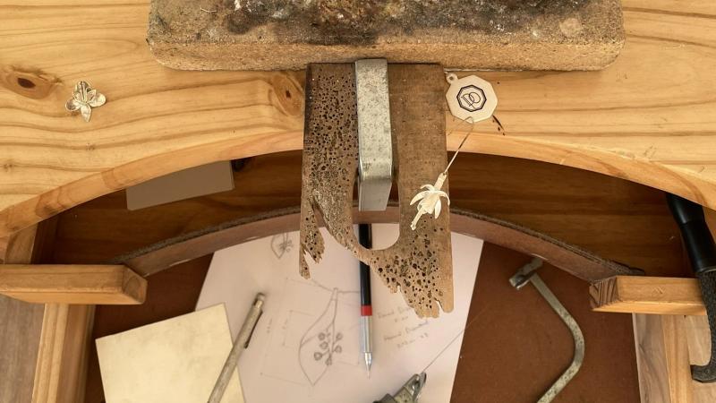 A detailed view of Dolores Ortega’s jewelry tools arranged on her workbench.
