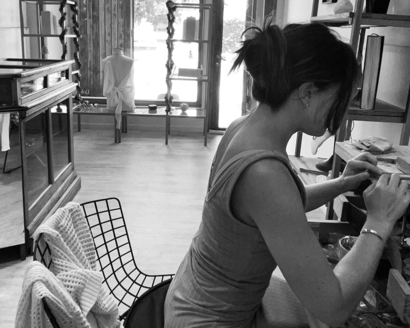 Dolores Ortega handcrafting a jewelry design with precision and focus.