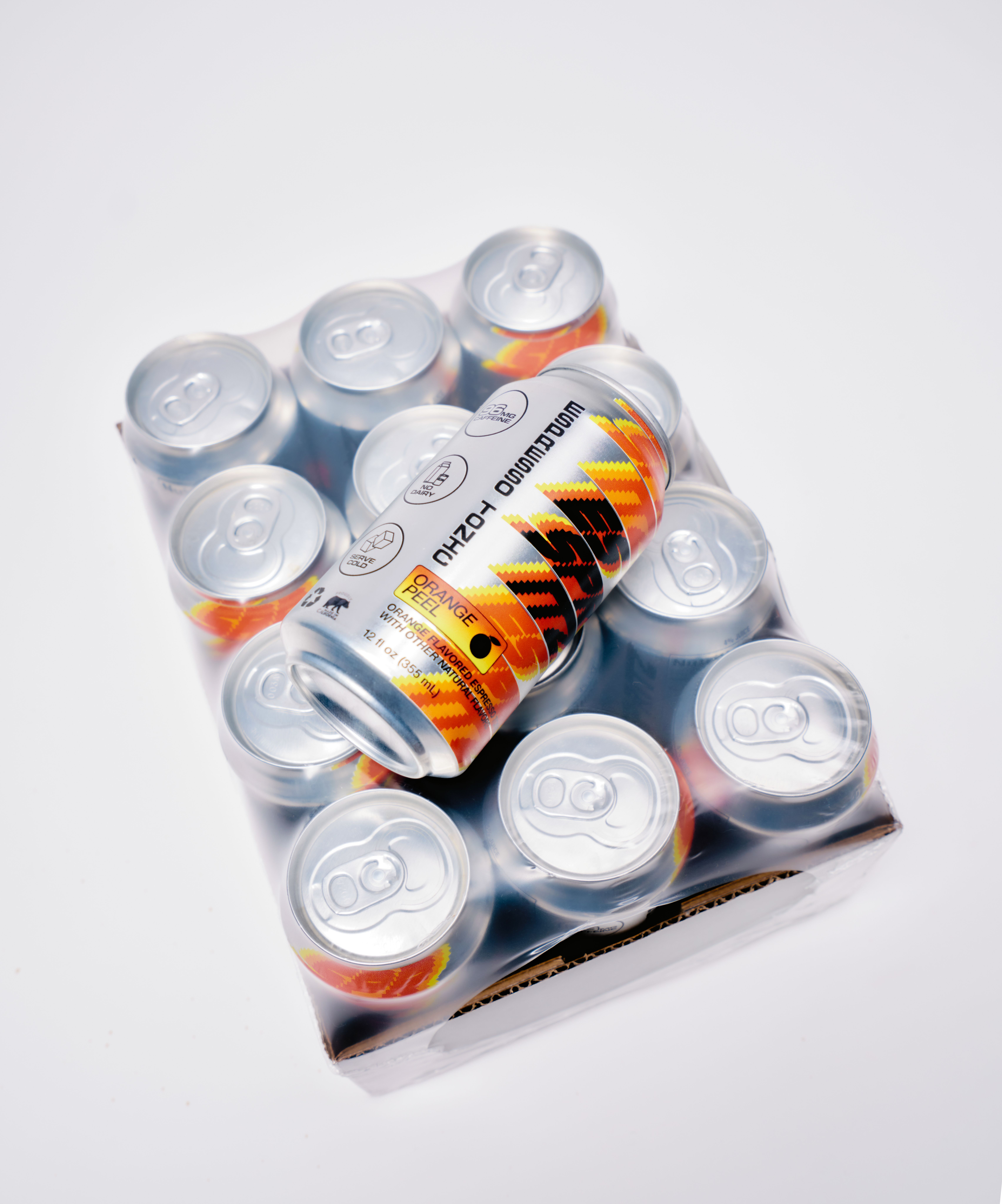 12-pack tray of Esspritz Orange espresso tonic cans shrink-wrapped in plastic, with one can placed diagonally on top against a white background