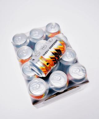 12-pack tray of Esspritz Orange espresso tonic cans shrink-wrapped in plastic, with one can placed diagonally on top against a white background