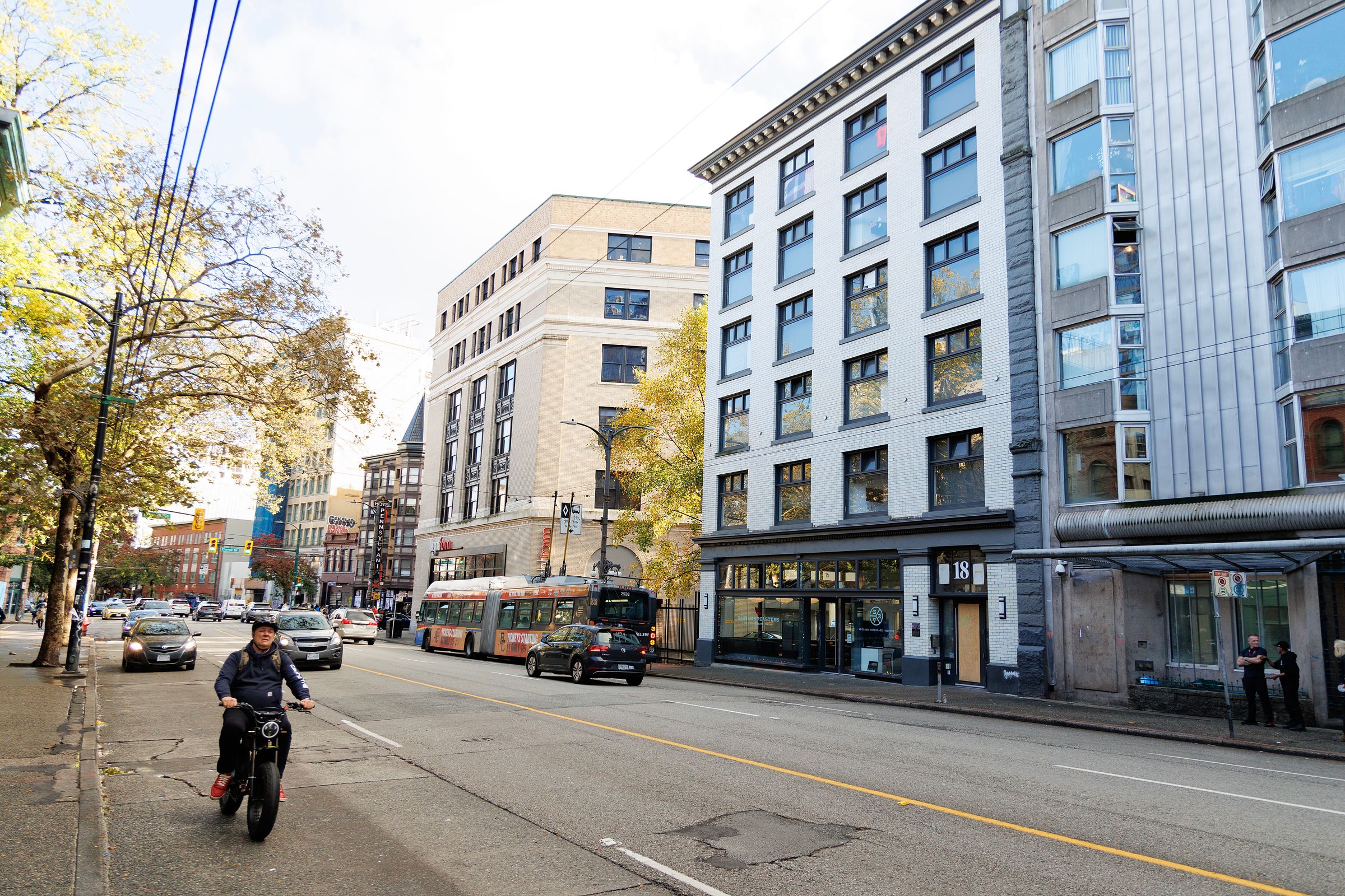 Hastings street properties with cars and motorbike on the road