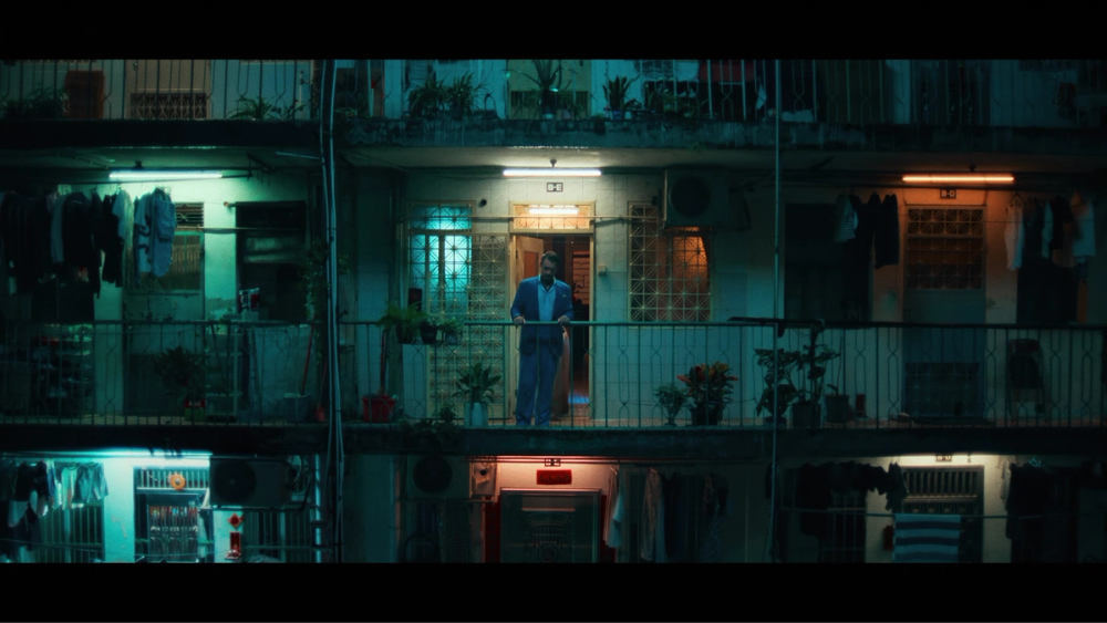 The apartment building exterior, lit with numerous INFINIBARs