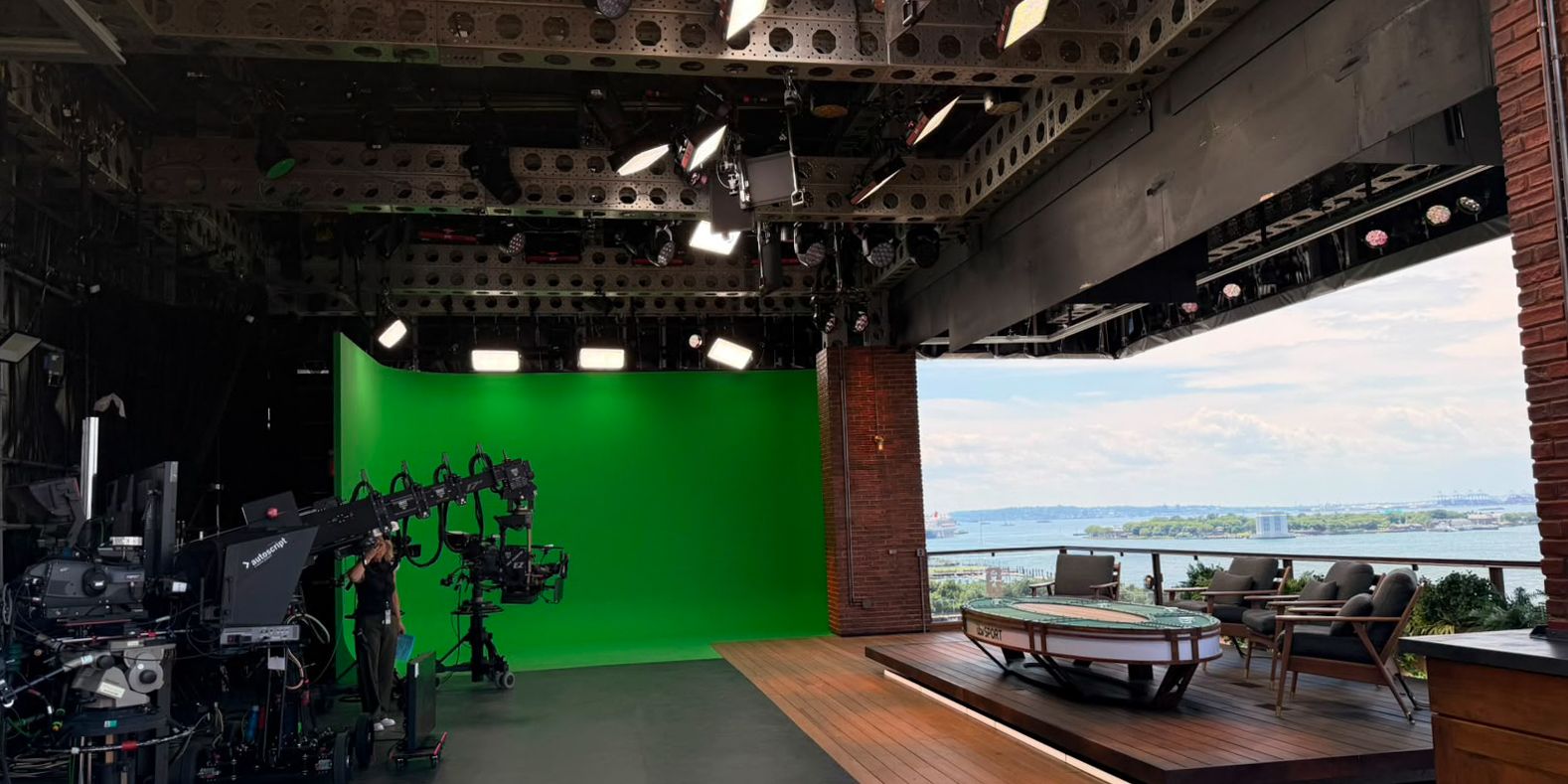Aputure lights hanging from the ceiling in a large studio environment