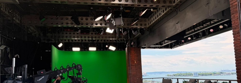 Aputure lights hanging from the ceiling in a large studio environment