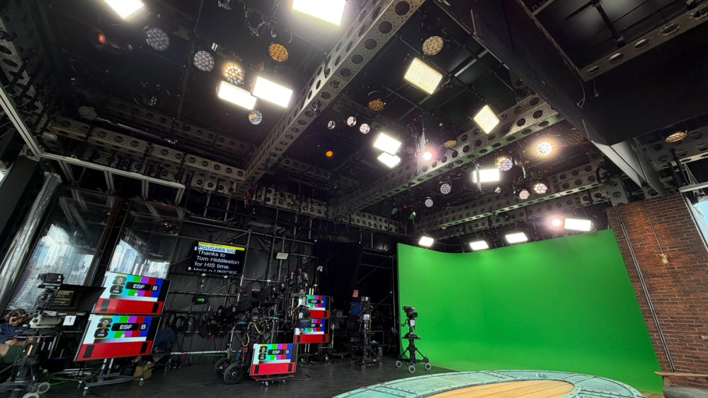 The studio space, including the balcony table and green screen cyc