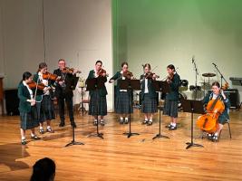 The String Group plays in the Auditorium.