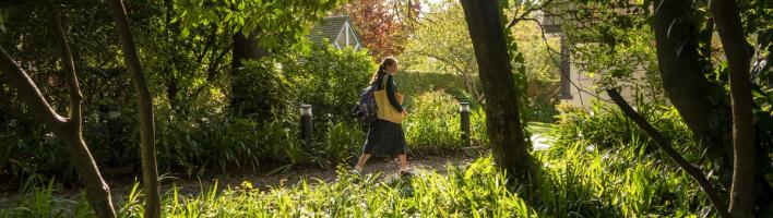 A student walks through the grounds to Chapel in the morning.