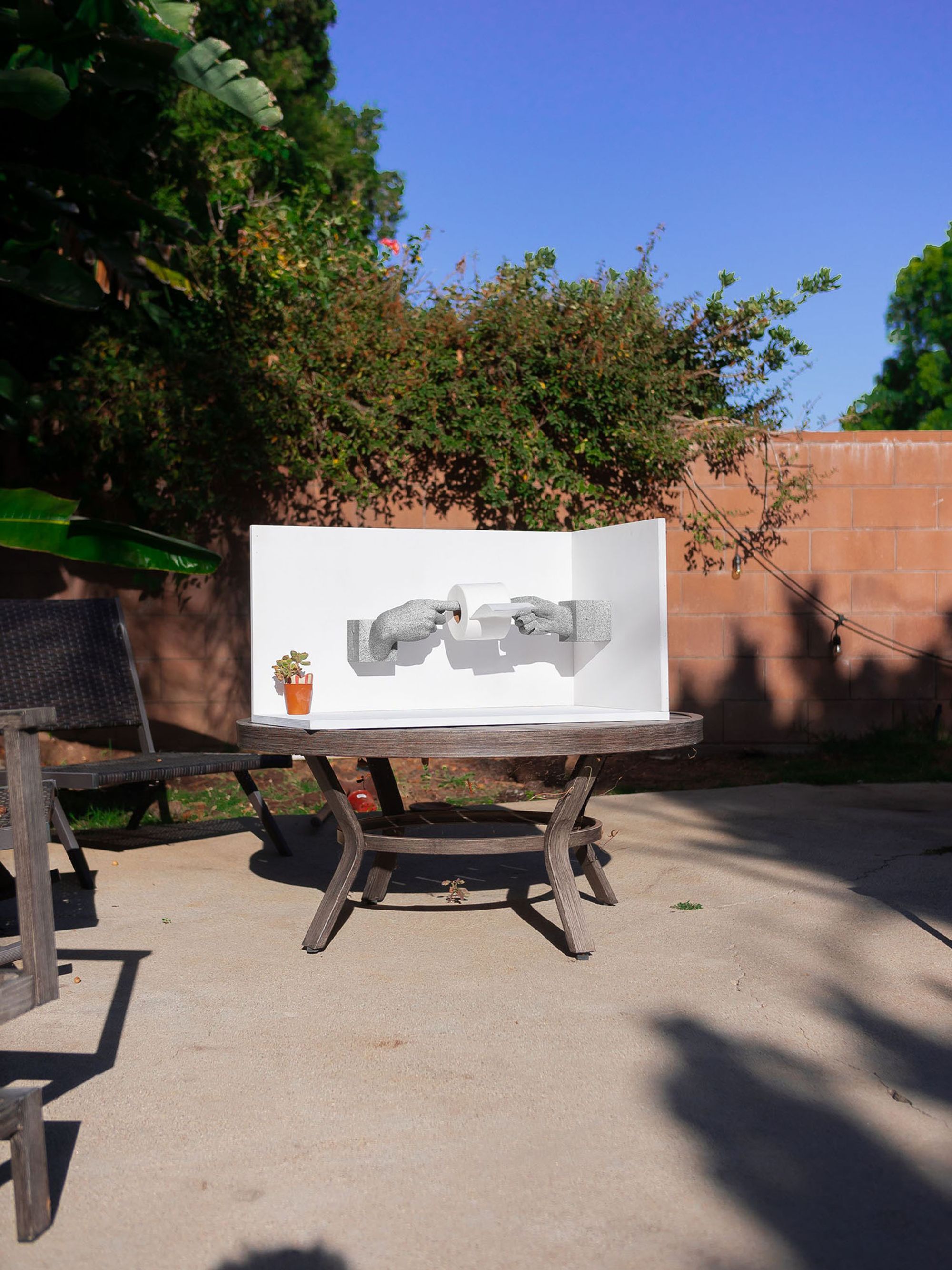 Toilet paper holder made out of cast plaster hands