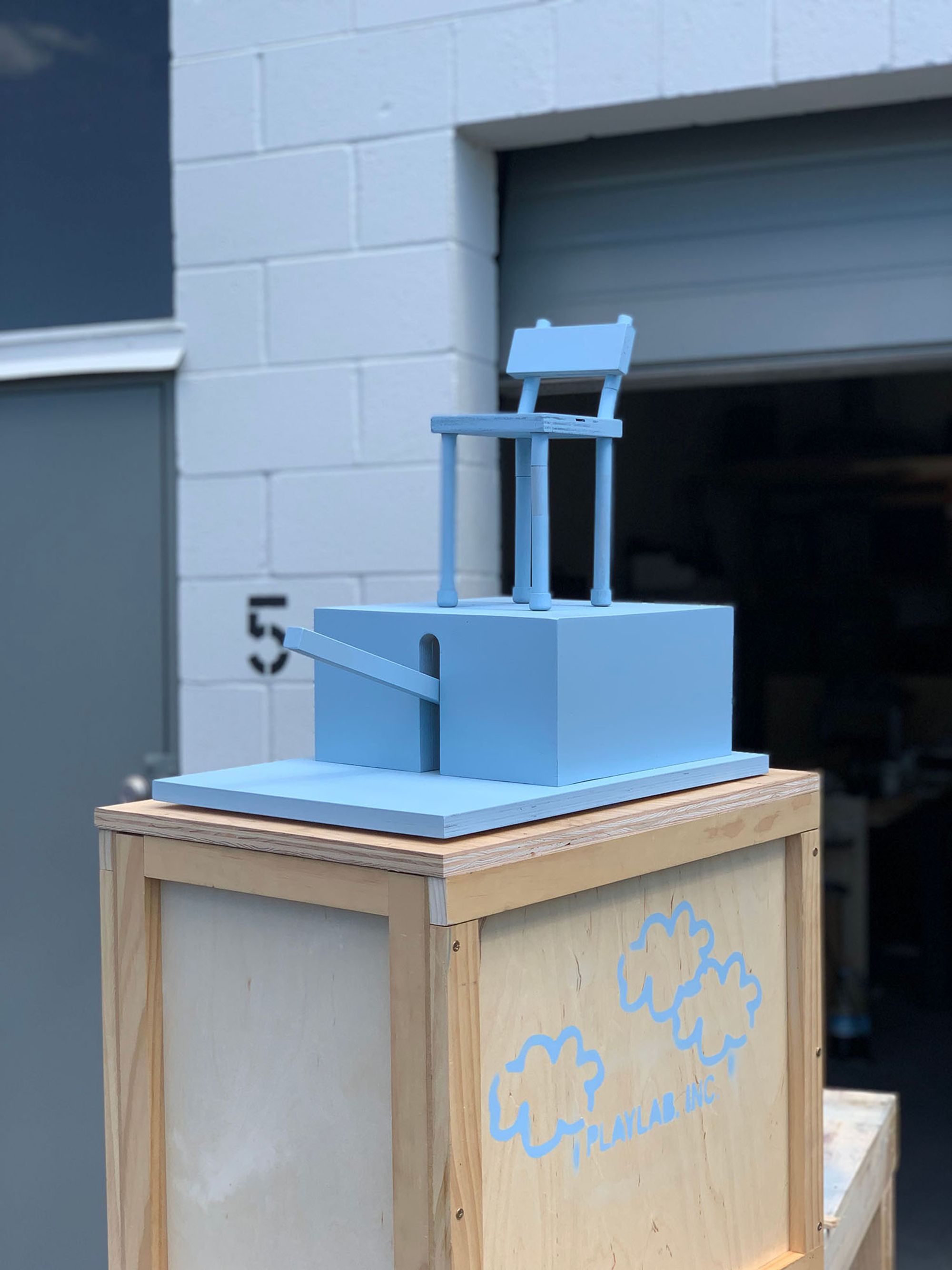 Chair on top of crate outside of workshop