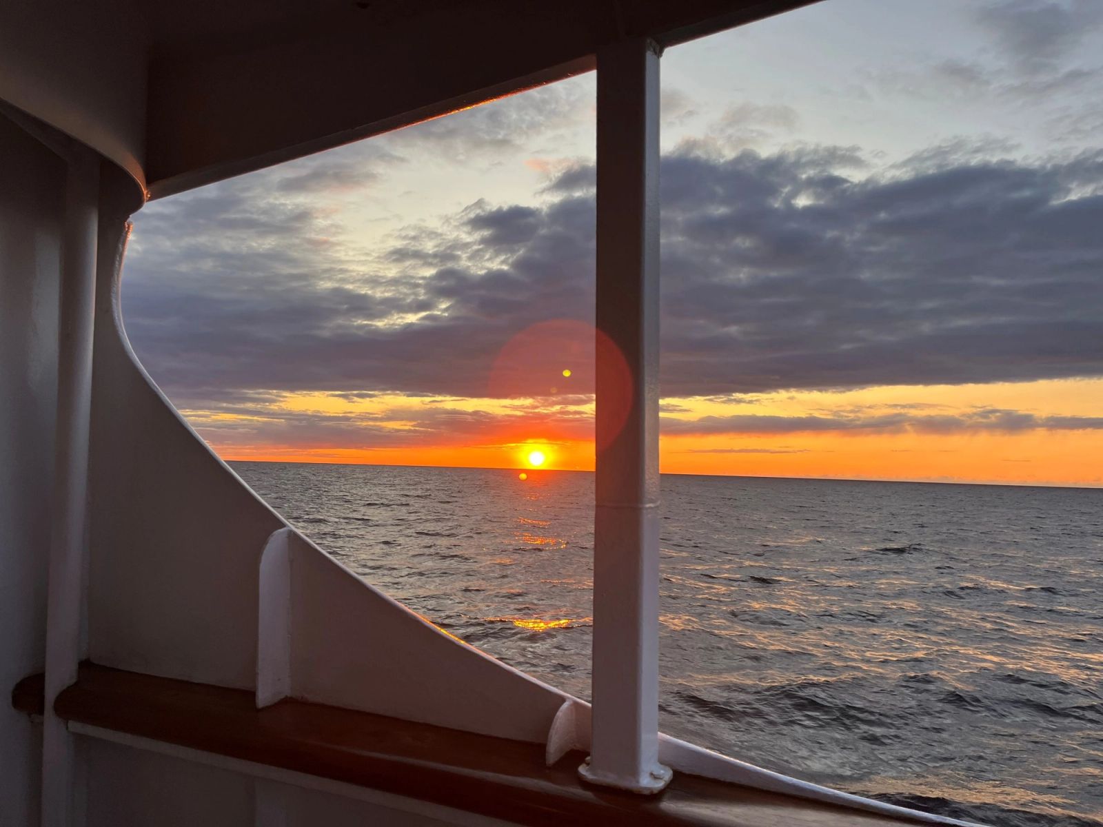 Sunset light through a salon window at sea