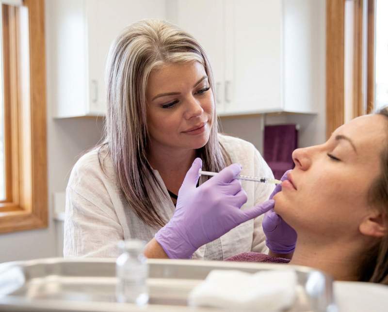 Jenni performing a lip filler treatment