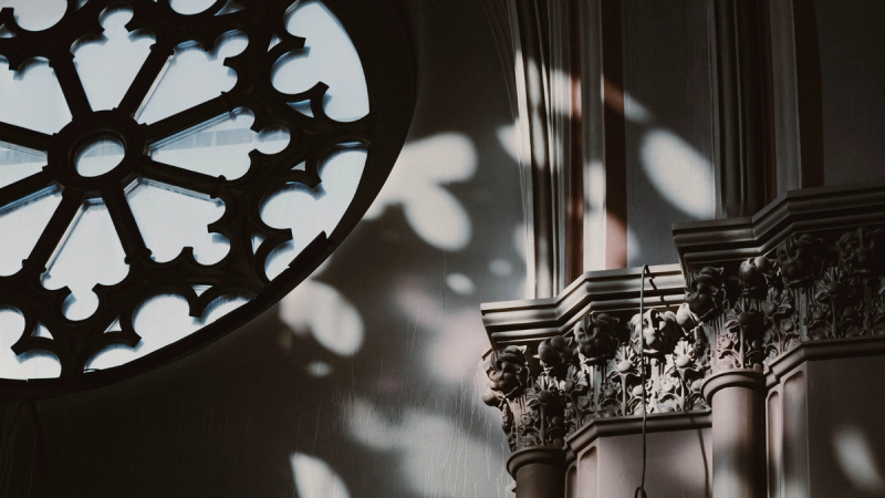 Light softly filtering through a rose window in a church.