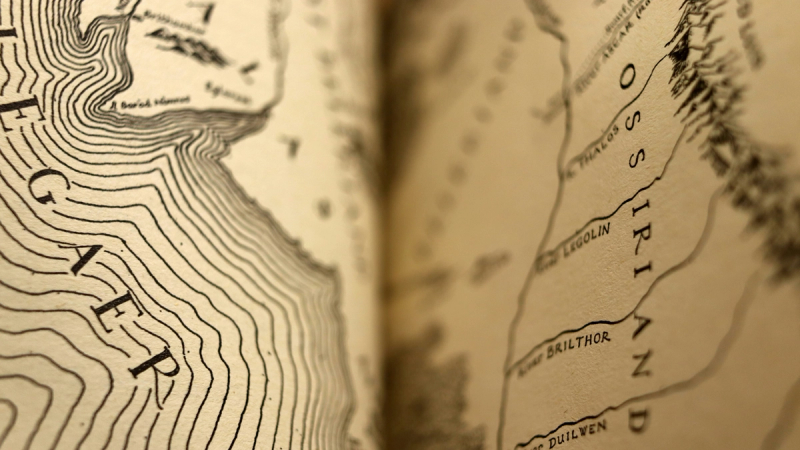 A close up of a map of Middle Earth in The Lord of the Rings book.