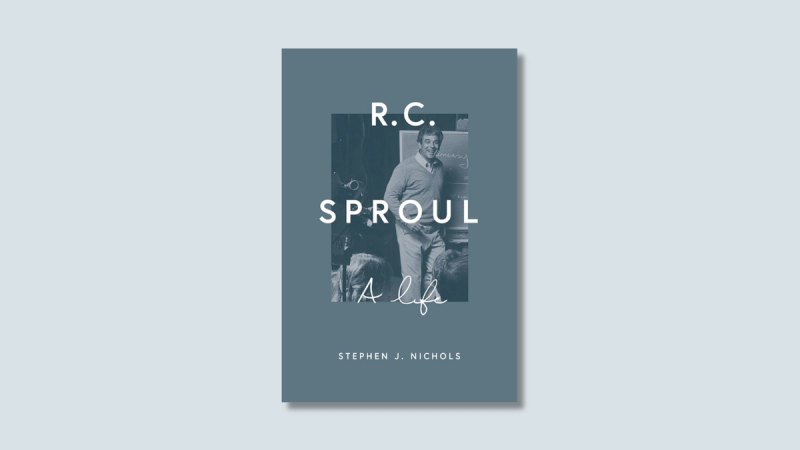 A book cover with a photo of R. C. teaching, over a pale blue background.