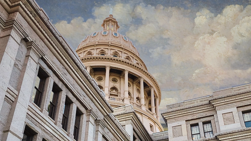 The Texas state capitol building beneath a soft cloudy sky.