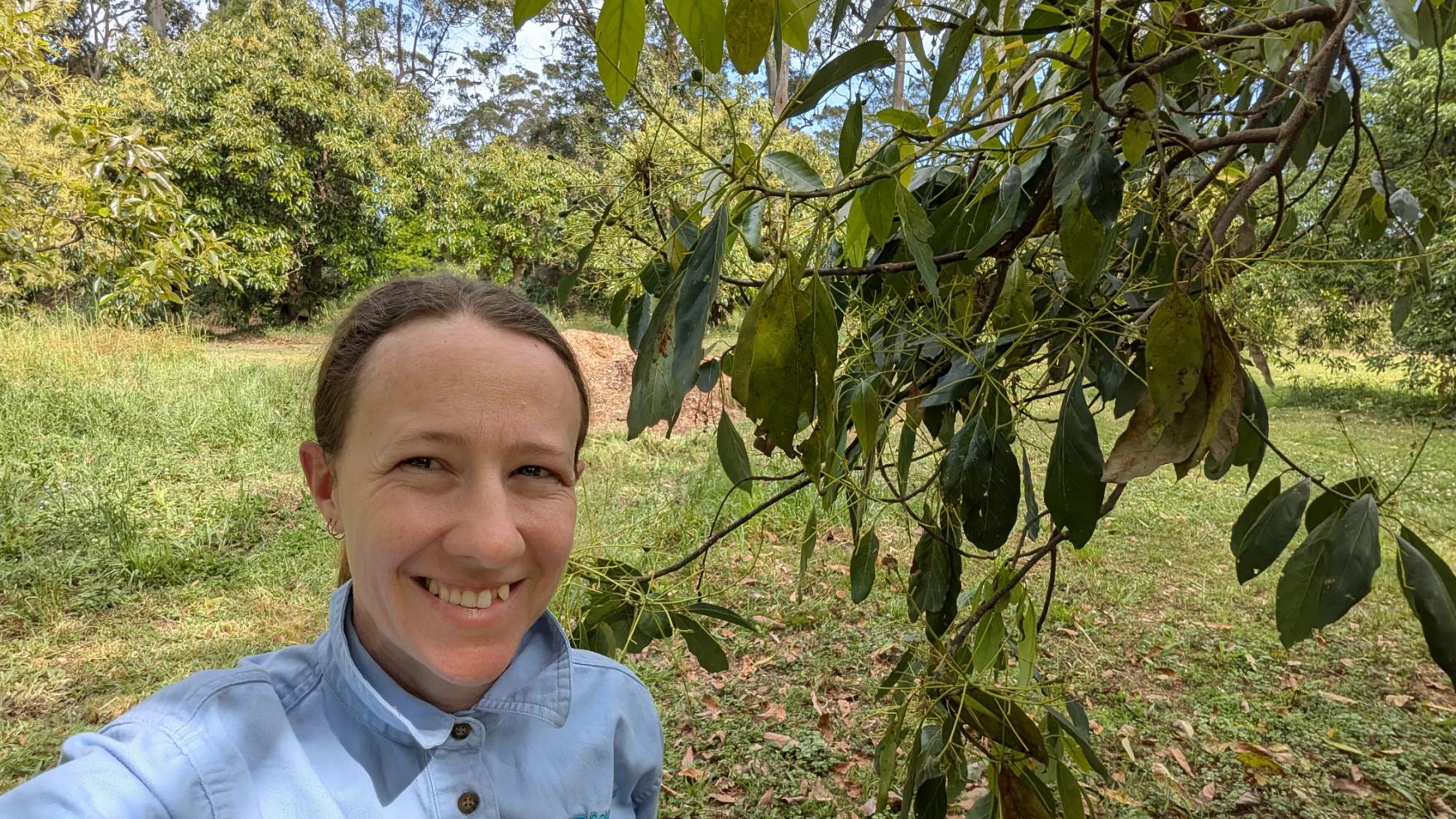 Dr Karina Griffin at the bench with a sample vial and microscope, Southern Cross University