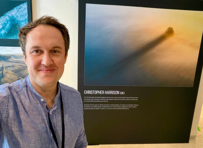 Christopher Harrison with his 1st Place winning photograph The Long Shadow exhibited in the Siena Natural History Museum.