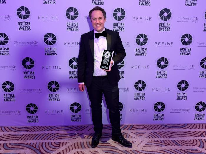 Christopher Harrison with his trophy from the British Photography Awards 2025, where his photograph The Long Shadow won the drone category.