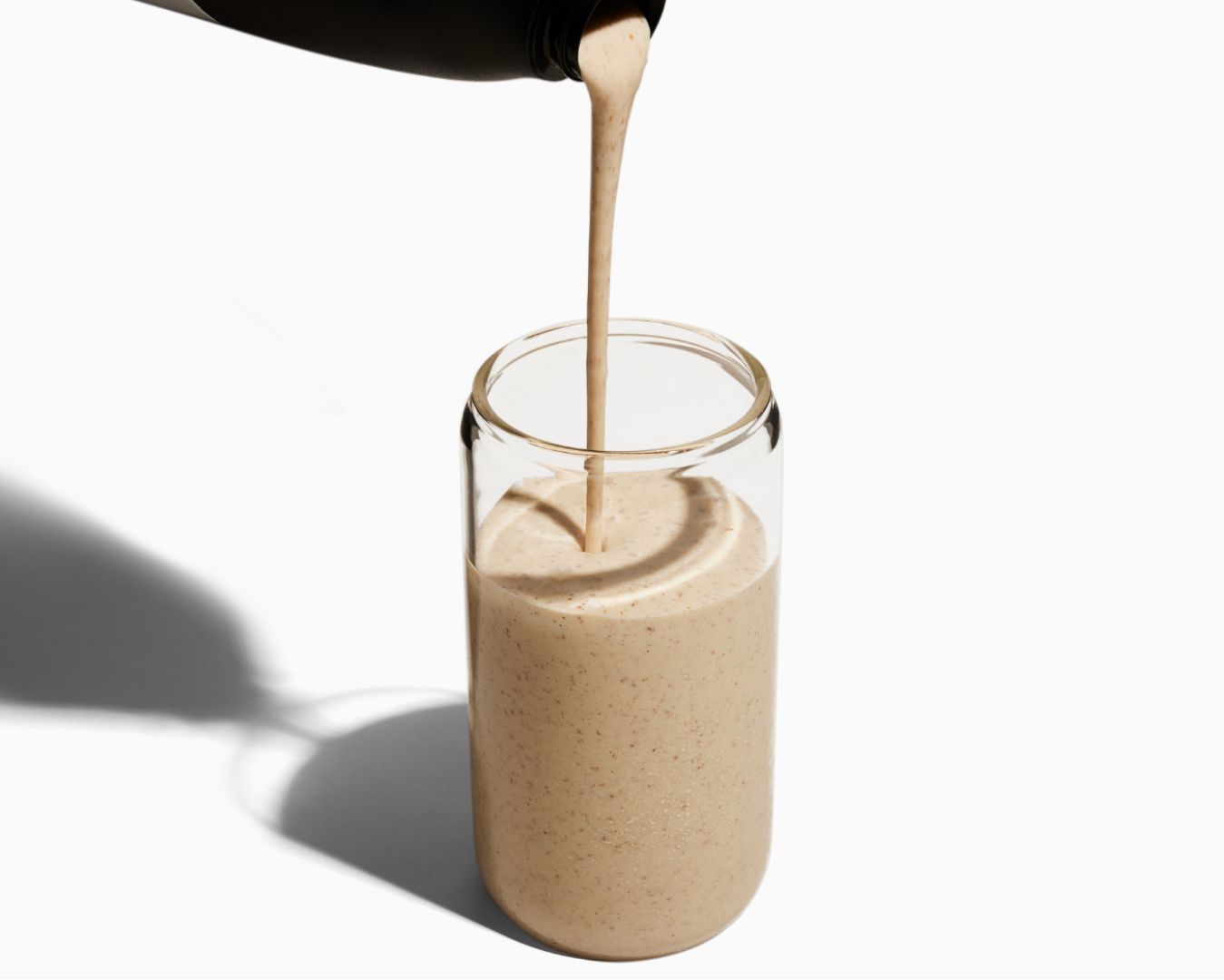 Image of Huel Black Edition meal replacement drink being poured from a shaker into a glass