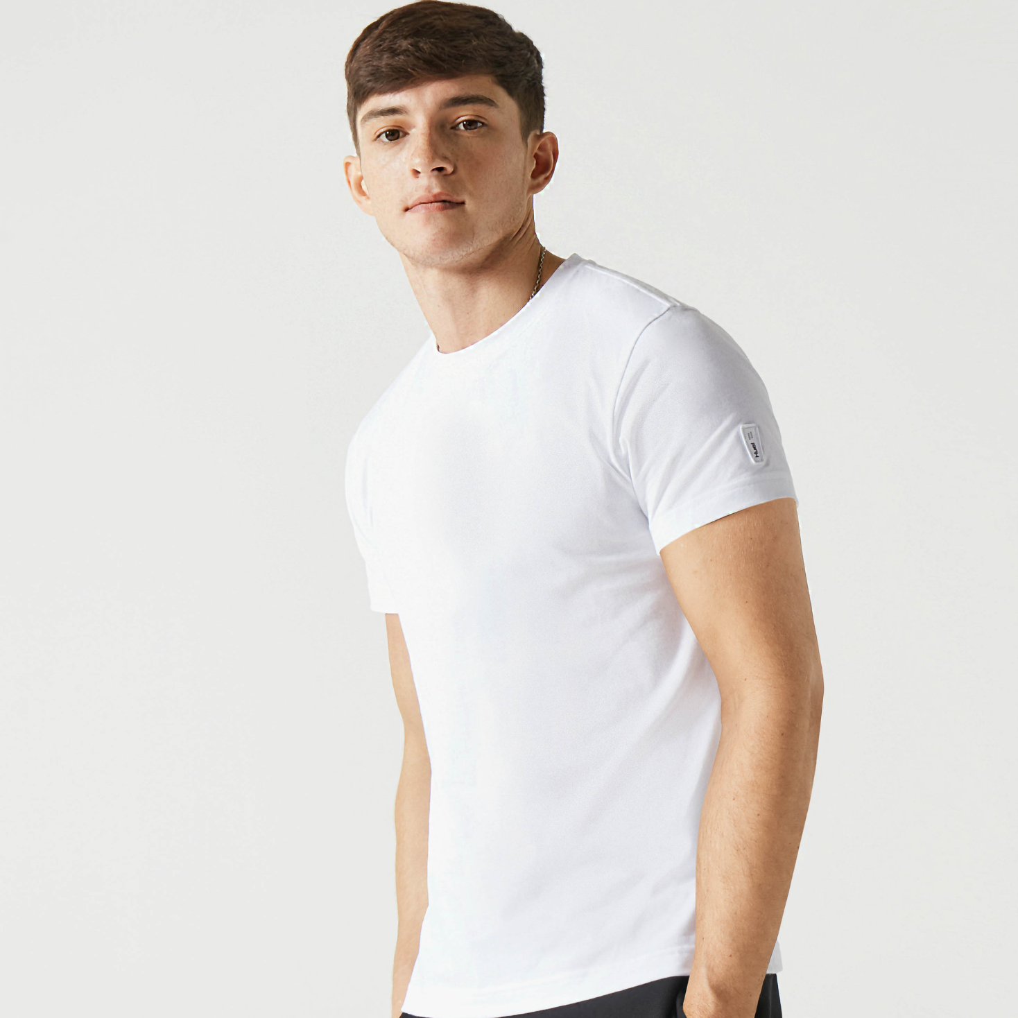 A man wearing the plain white Huel t-shirt