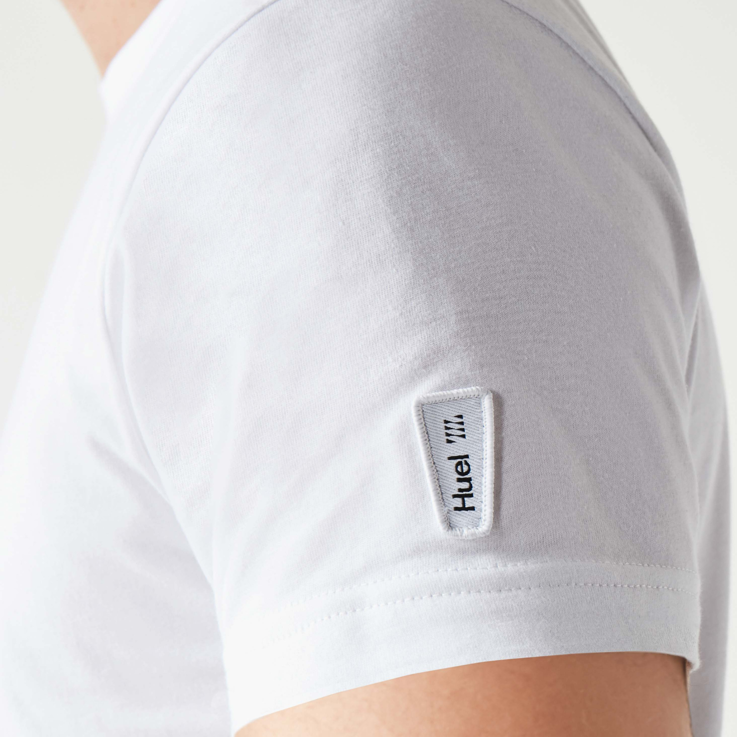 A close up of the sleeve of a white huel t-shirt