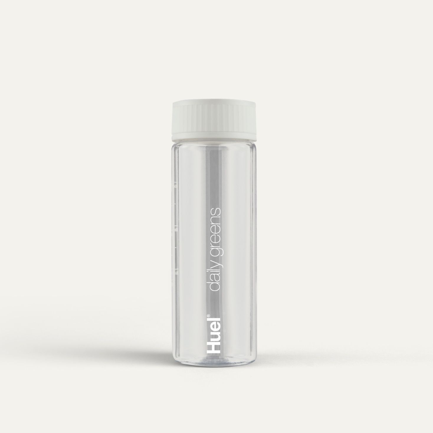 Clear Huel Daily Greens Bottle on a neutral colour background