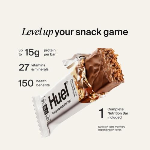 Huel Complete Protein bar with its wrapper ripped open on a neutral colour background