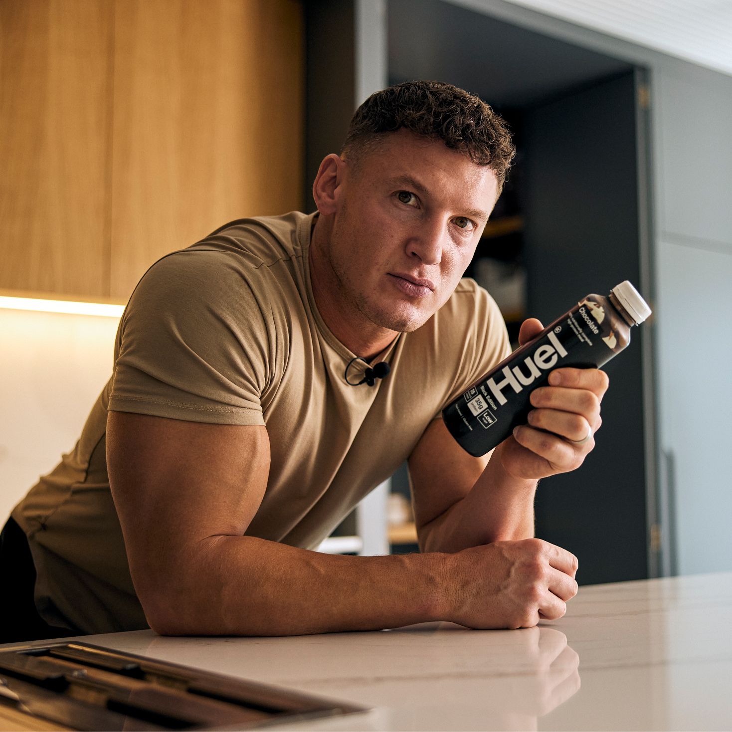 Matt Morsia holding a bottle of chocolate Black Edition Ready-to-drink