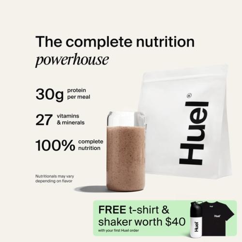 A bag of Huel powder next to a glass containing a Huel drink on a neutral background