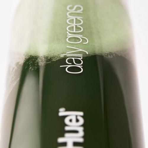 Extreme close-up on Huel Daily Greens bottle filled with greens drink liquid