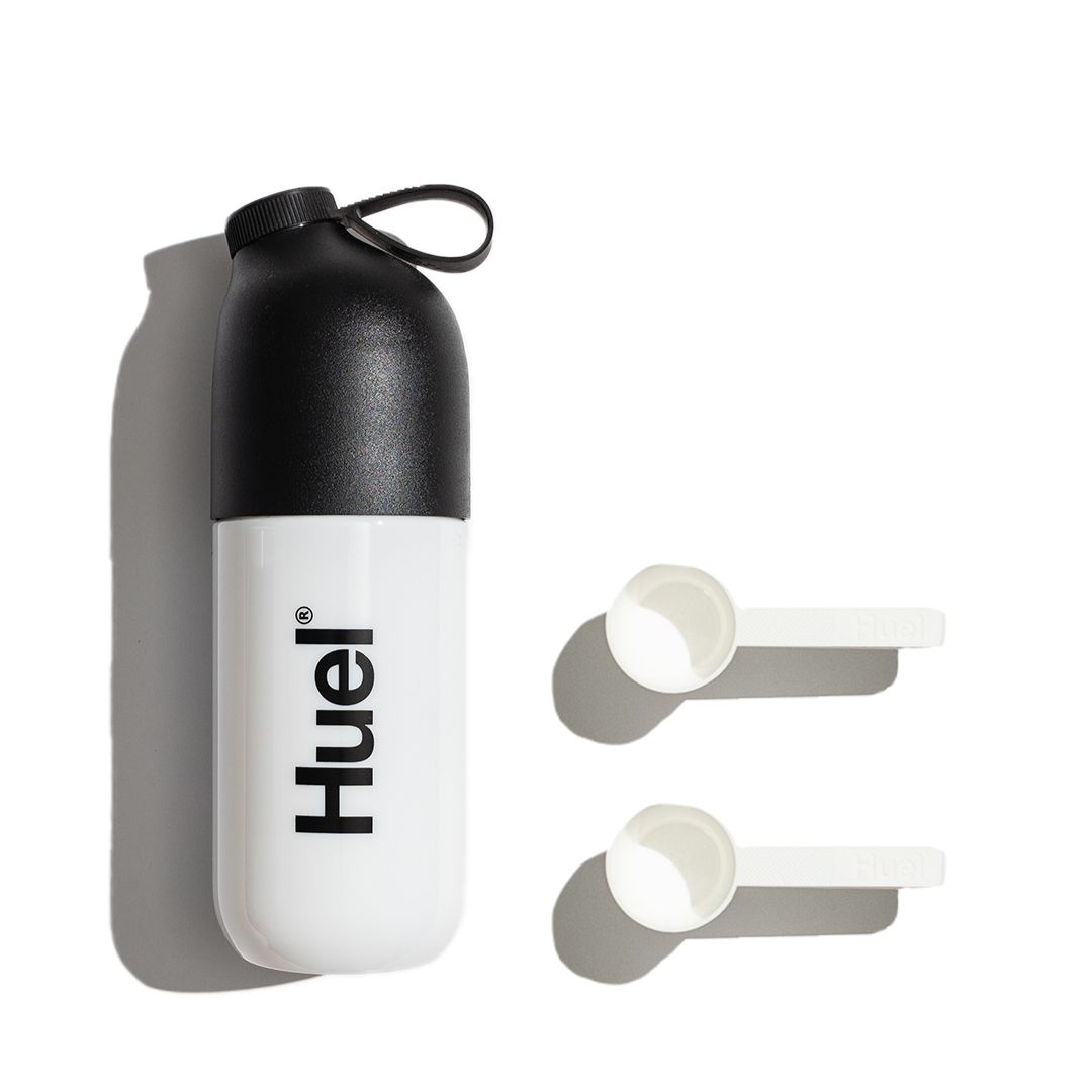 Huel shaker next to two scoops
