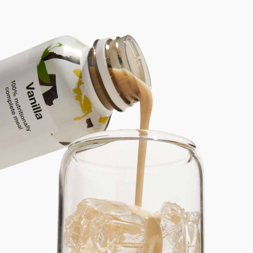 Vanilla Huel RTD being poured into a glass with ice