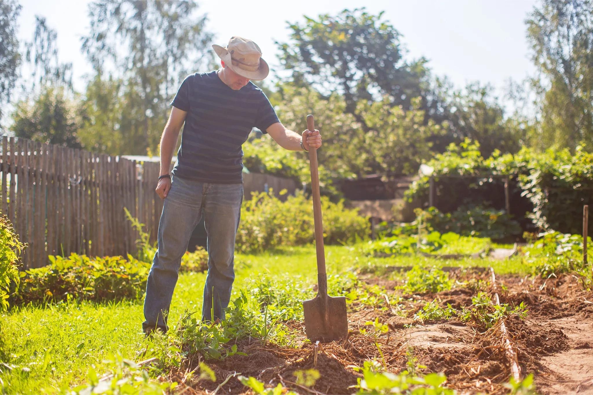 man gardening holding a spade