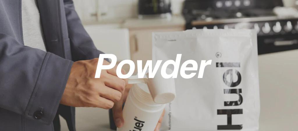 Image of a man tipping Huel powder into his Huel shaker