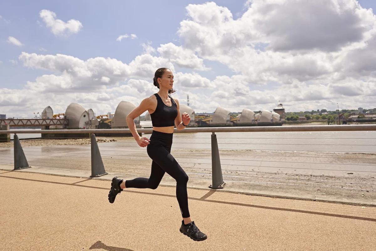 woman running on a path alongside a river